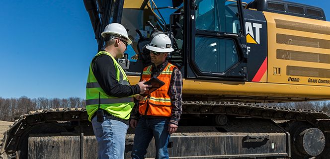 Two operators looking at a phone